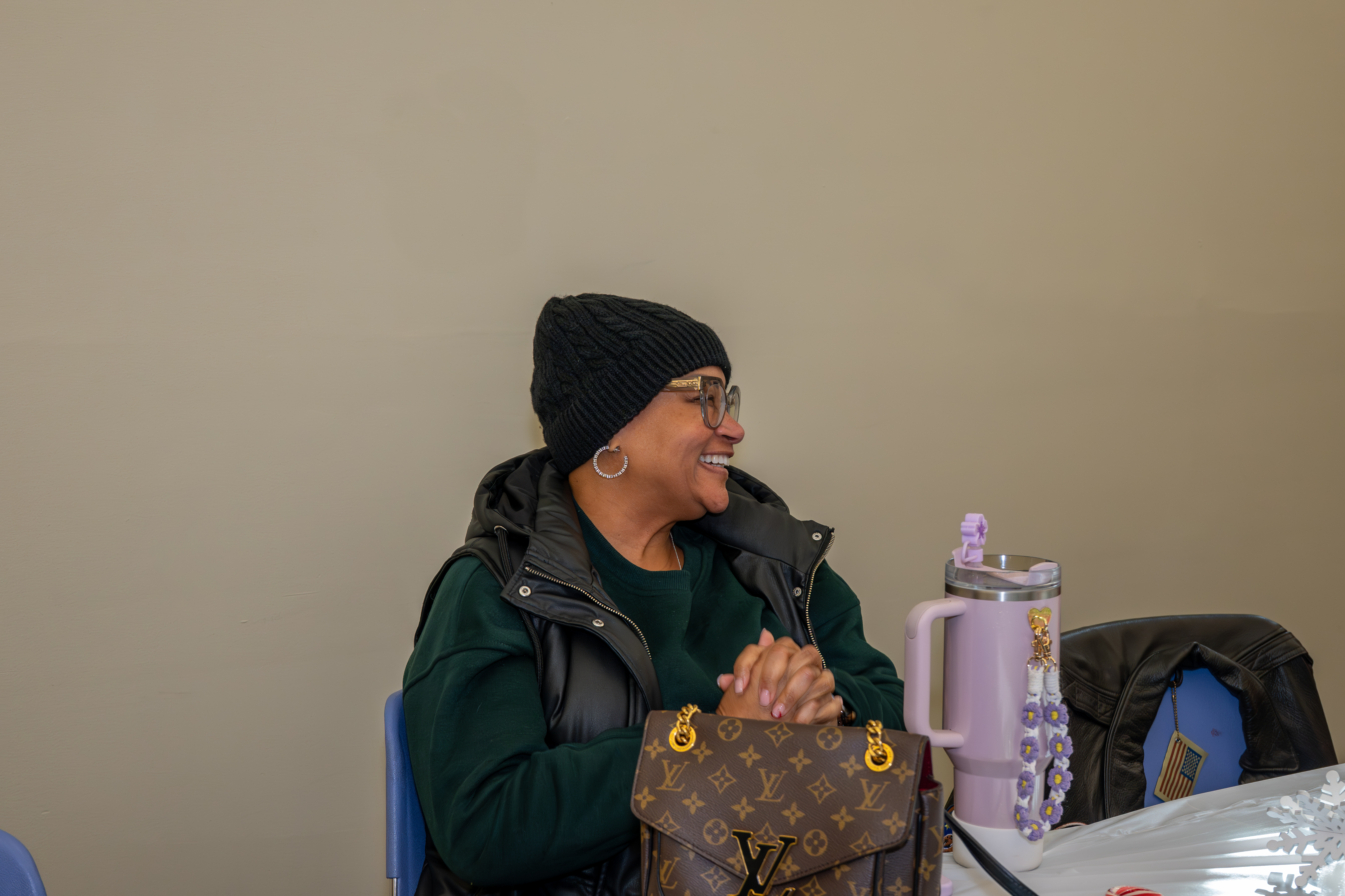 Lakema Freeland listens as her daughter, Kamora Freelend, the youngest African-American female pilot to earn her private pilot's license, speaks to middle school students at a meeting of Jack and Jill of America, Staten Island Tweens, at the College of Staten Island in Willowbrook on Saturday, Dec. 20, 2025. (Owen Reiter for the Advance/SILive.com)