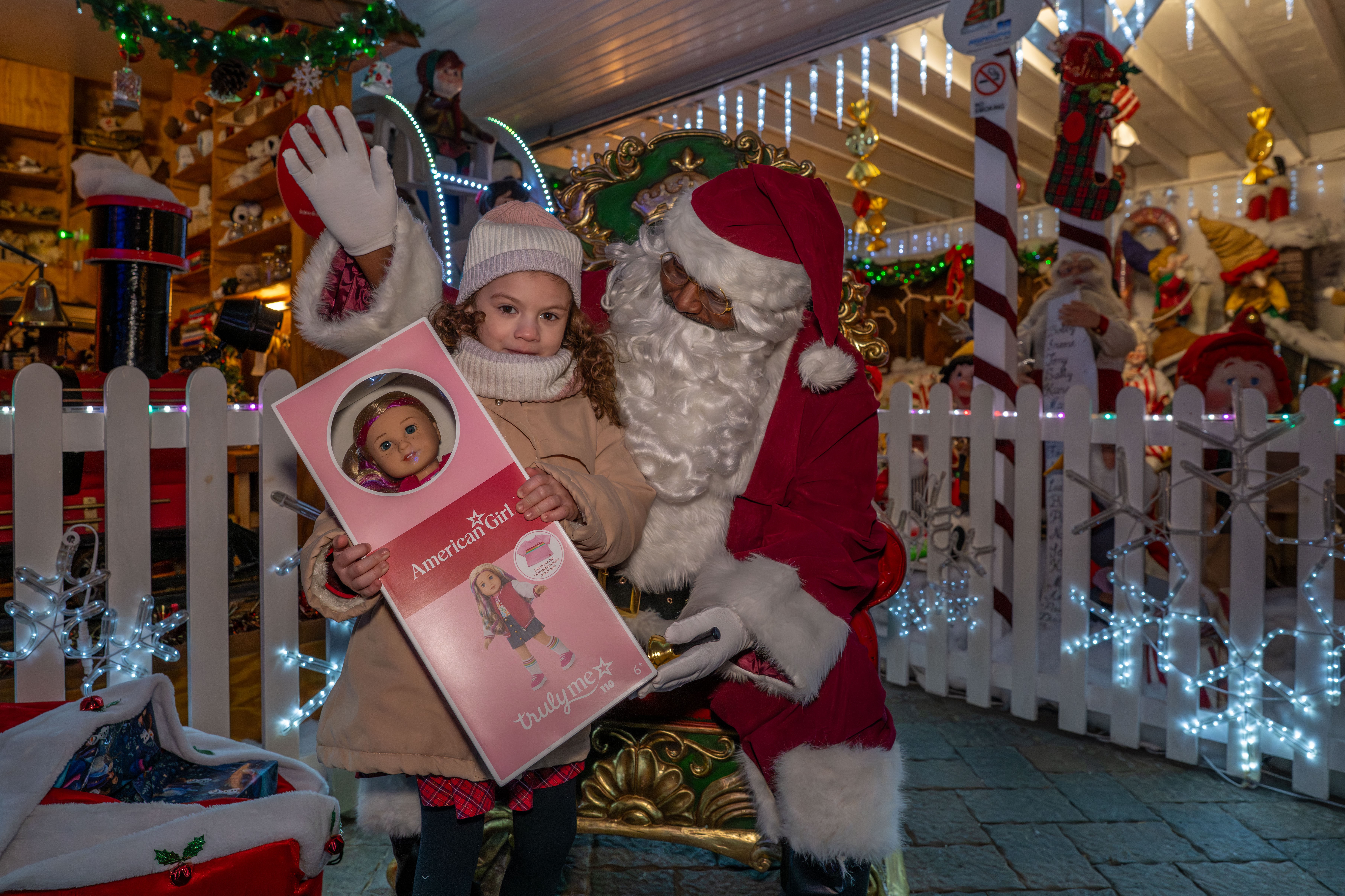Julissa Irrizarry, 6, granddaughter of Taisha Figueroa, a Northwell Staten Island University Hospital employee who is being honored with a Day of Surprises, receives an American Girl doll at the DeMartino Christmas House in Charleston on Tuesday, December 16, 2025. (Owen Reiter for the Advance/SILive.com)