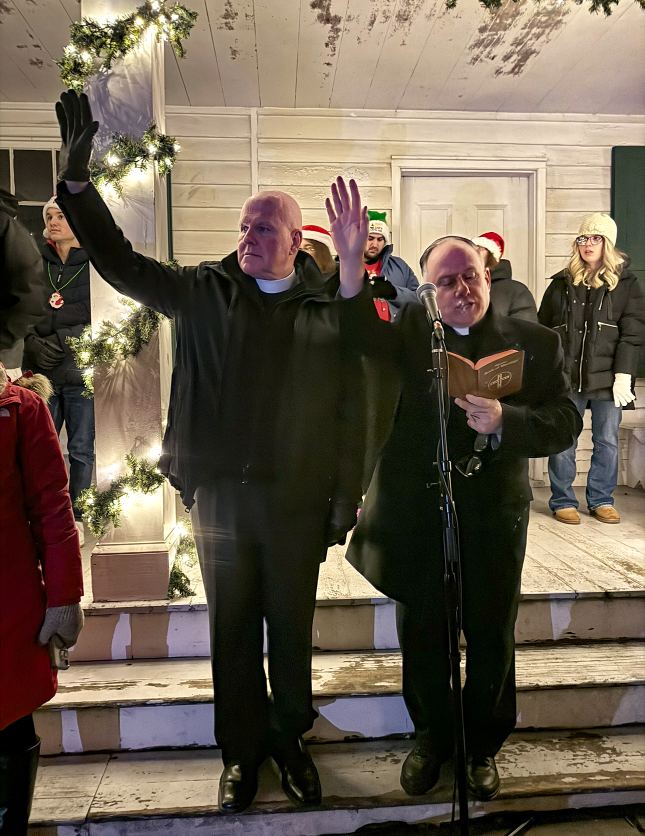 Pastor Terrence Buckley of St. Andrew Church, together with Rev. Michael Martine blesses the Christmas tree at Historic Richmondtown on Dec. 5, 2025. (Steve White for the Advance/SILive.com)
