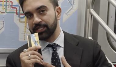Zohran Mamdani flashes a MetroCard while filming an episode of "Subway Takes with Kareem Rahma," where he discusses issues affecting subway drivers.