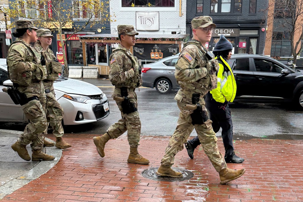 Members of the National Guard and an officer from the Washington Metropolitan Police Department on foot patrols in the U Street neighborhood of Washington, Sunday, Nov., 30, 2025.