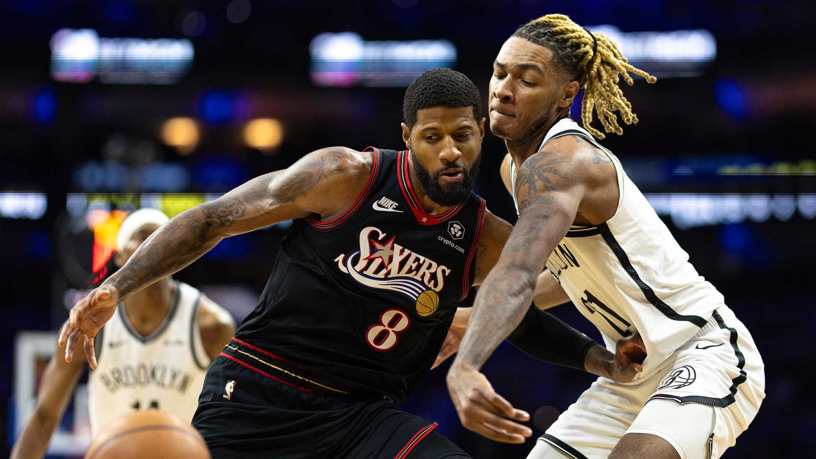 Brooklyn Nets forward Noah Clowney (21) knocks away the ball from Philadelphia 76ers forward Paul George (8) during the third quarter at Xfinity Mobile Arena.