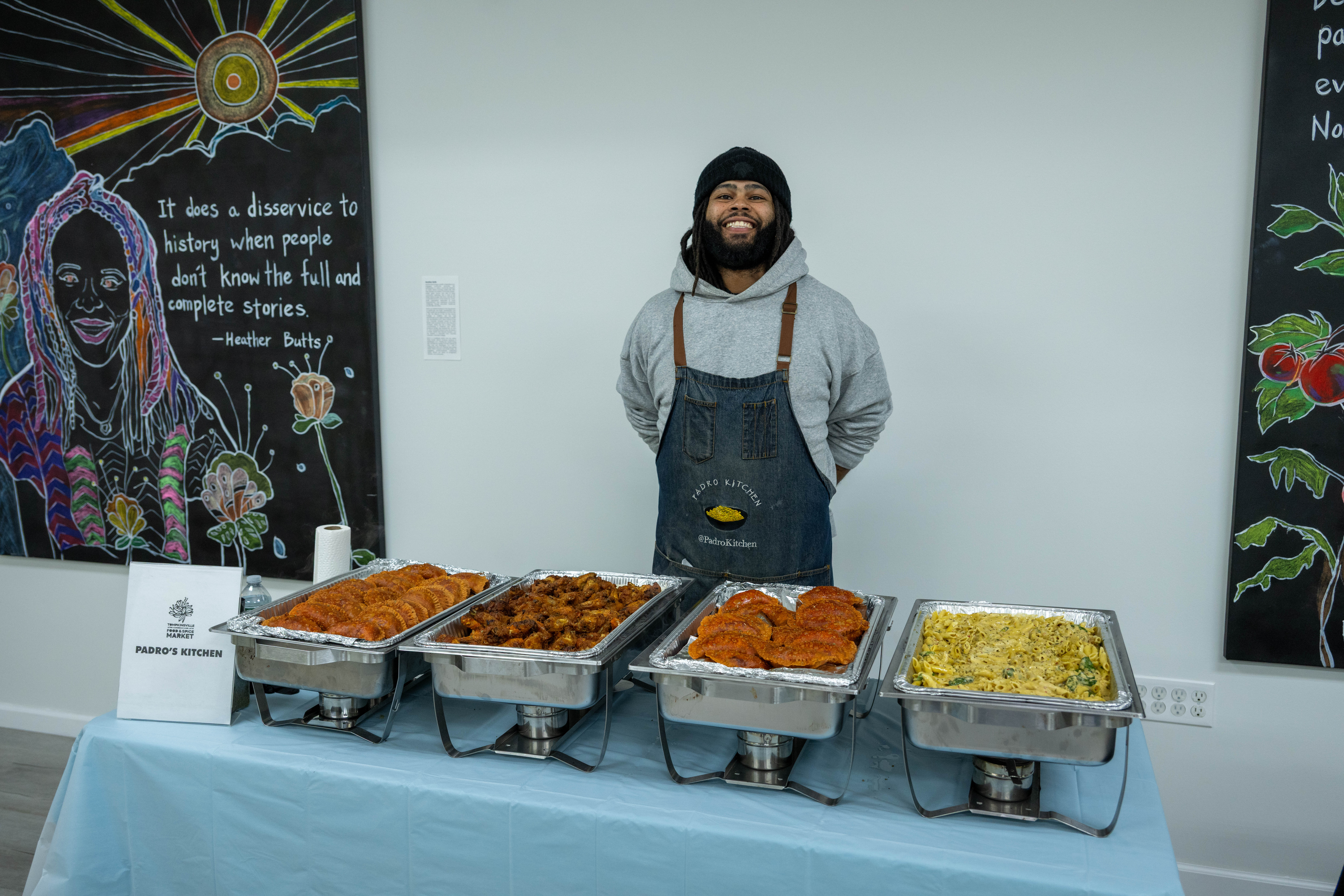 Jonathan Prado, owner/chef of Prado’s Kitchen, gets ready to serve food at the grand opening of the Staten Island Urban Center’s new storefront at 206 Bay Street in Tompkinsville on Saturday, December 6, 2025. (Owen Reiter for the Advance/SILive.com)
