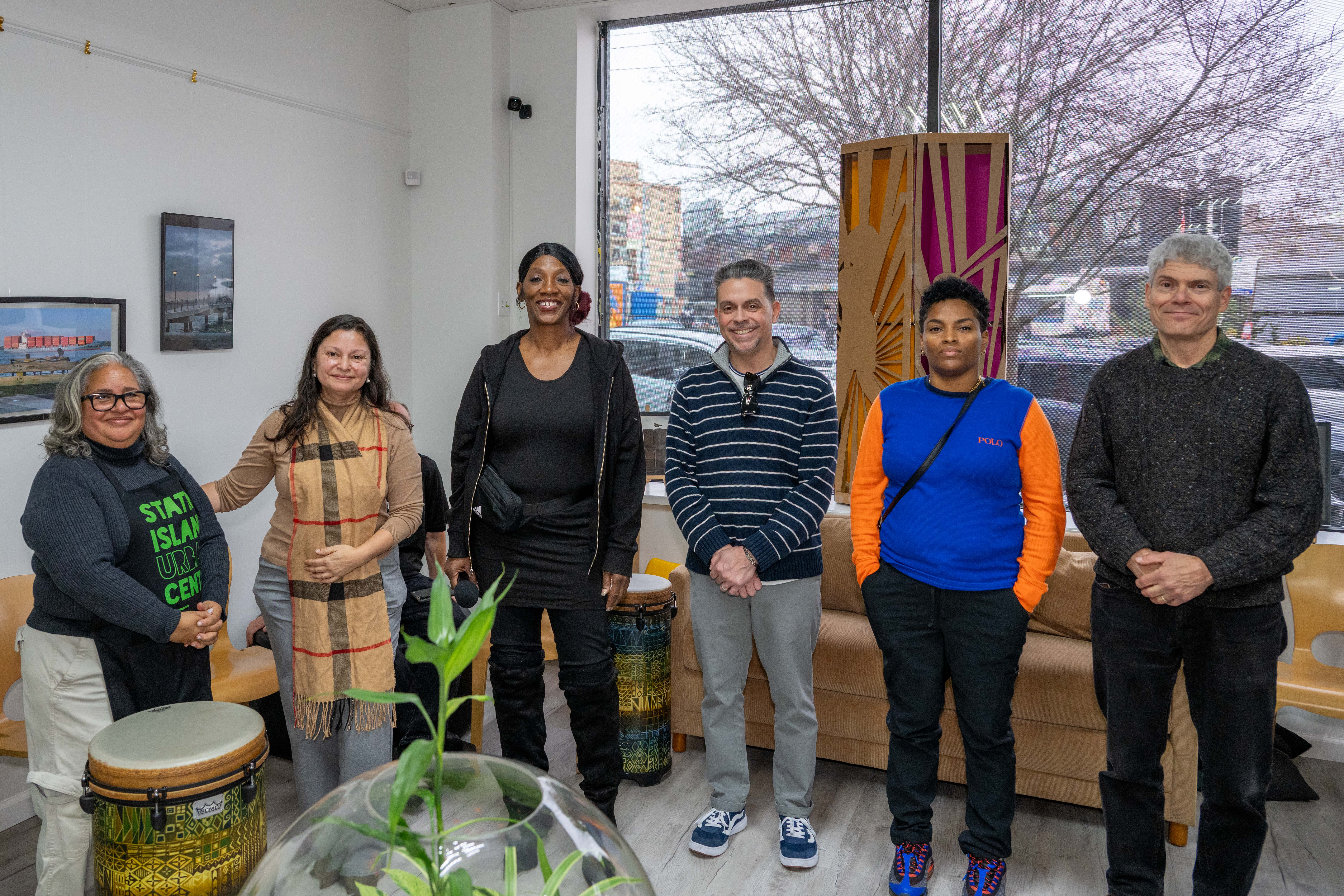 From the left, Kelly Vilar, founder and CEO, is joined by Dr. Maria Romero, Dr. Sheila Mashack, Judge Raymond Rodriguez, Rouby Tucker, and Professor Paul Gallay from Columbia University at the grand opening of the Staten Island Urban Center’s new storefront at 206 Bay Street in Tompkinsville on Saturday, December 6, 2025. (Owen Reiter for the Advance/SILive.com)