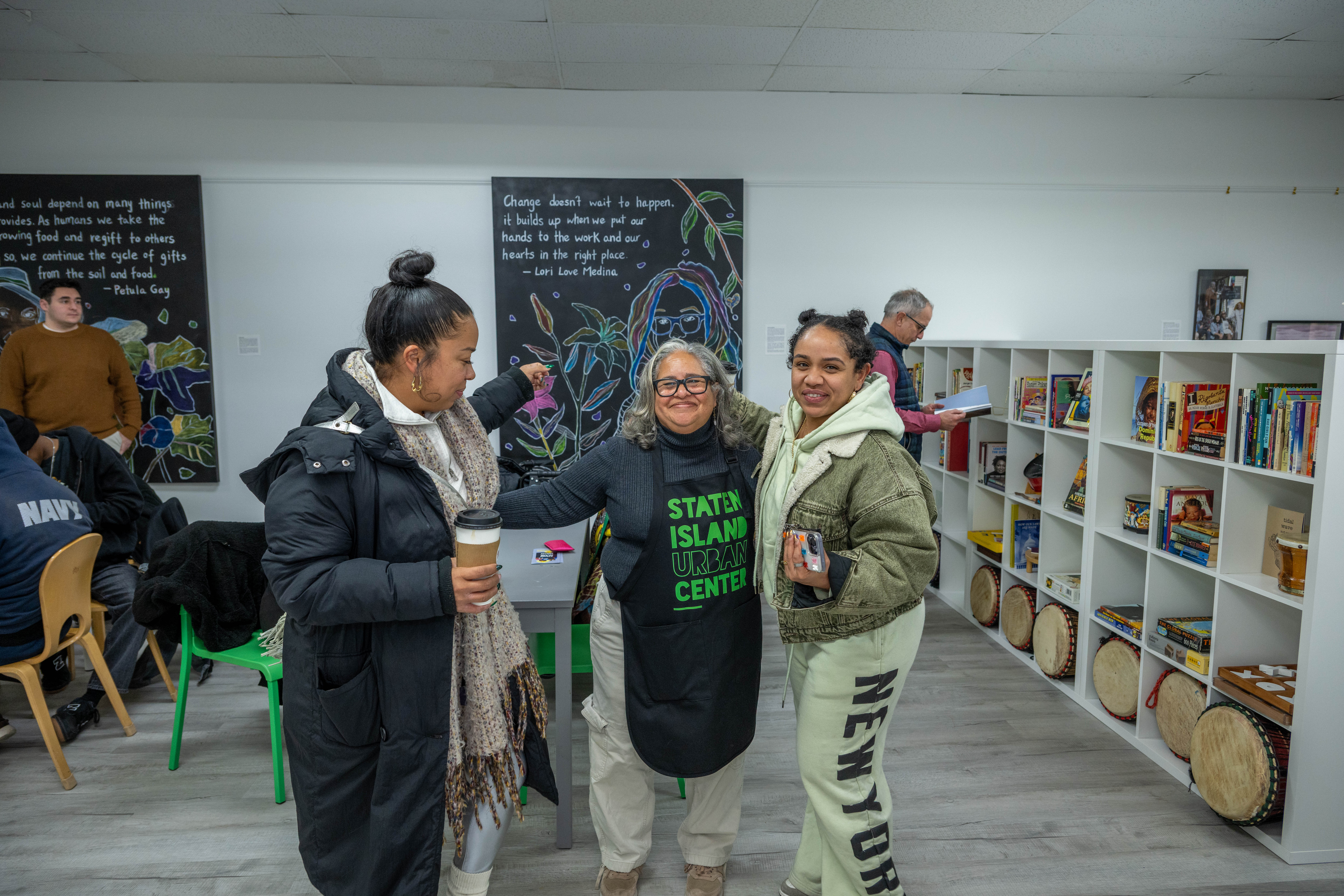 Kelly Vilar, center, founder and CEO, welcomes guests to the grand opening of the Staten Island Urban Center’s new storefront at 206 Bay Street in Tompkinsville on Saturday, December 6, 2025. (Owen Reiter for the Advance/SILive.com)