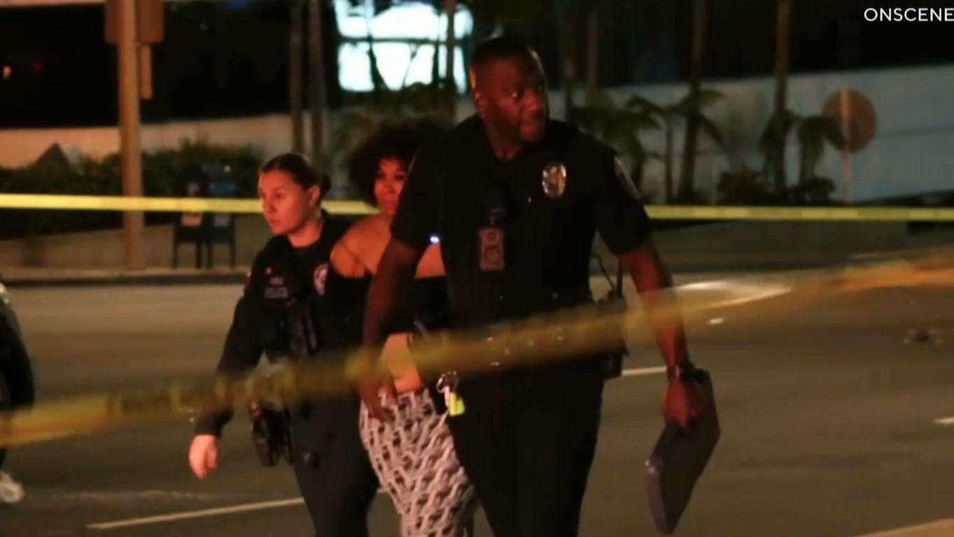 A woman is taken into custody on Sunday May 4,...