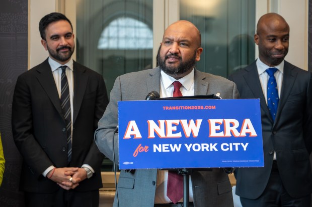 Ahmed Tigani, center, speaks at the Charles A. Dana Discovery Center in Manhattan on Wednesday, Dec. 31, 2025, after Mayor-elect Zohran Mamdani, left, appointed him as commissioner of the Department of Buildings. (Barry Williams/ New York Daily News)