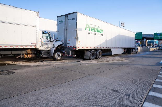 A woman was killed and her two passengers hospitalized after her white Infiniti sedan crashed into a tractor-trailer and a box truck on Bruckner Blvd. near Sheridan Blvd. in the Bronx early Friday, Dec. 5, 2025. (Theodore Parisienne / New York Daily News)