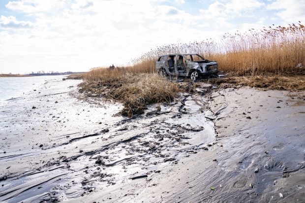 FDNY land and marine units, along with Department of Environmental Conservation Police Officers, responded after an SUV became fully engulfed in flames after it was driven into the Marine Park Salt Marsh and left at the edge of the Gerritsen Inlet in Brooklyn on Friday February 7, 2025. 0936. (Theodore Parisienne / New York Daily News)
