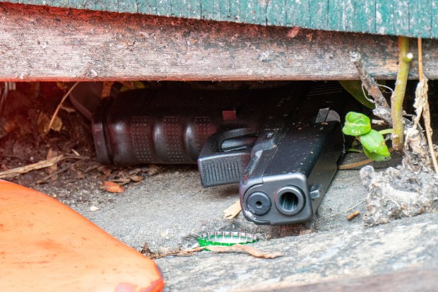 A gun is pictured on Bedford Ave., just south of Eastern Pkwy, after a mass shooting at the Taste of the City Lounge on Franklin Ave. in Crown Heights, Brooklyn, on Sunday, Aug. 17, 2025. 