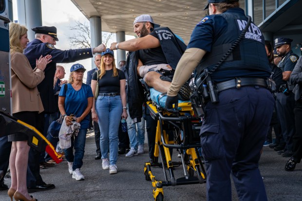 (Detective Corey Fisher is greeted by Chief of Department John Chell) Shot NYPD Detective Corey Fisher is greeted by fellow Officers, including Commissioner Jessica Tisch, as he leaves Jamaica Hospital in Queens on Monday August 25, 2025. 1100. (Theodore Parisienne / New York Daily News)