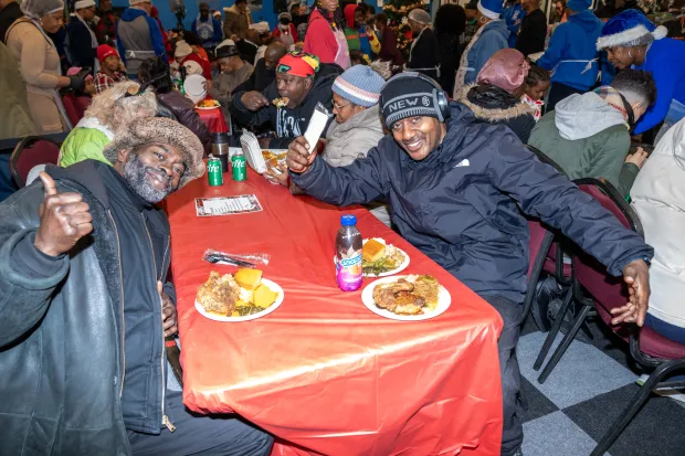 Rev. Al Sharpton, along with Gwen Carr and elected officials including John Liu and Gale Brewer, serve food to a large and appreciative crowd at the National Action Network Headquarters on W. 145th St. in Manhattan on Thursday, Dec. 25, 2025. (Theodore Parisienne / New York Daily News)