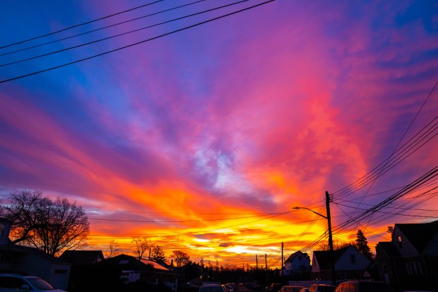 Vivid colors are seen here in the skies over Rosedale and Valley Stream as the Sun rose on Saturday January 18, 2025. 0659. (Theodore Parisienne / New York Daily News)