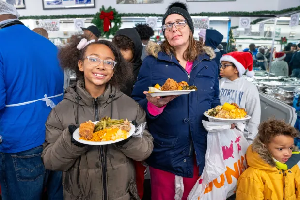 Sabrina Barden and her children are pictured at the National Action Network Headquarters on W. 145th St. in Manhattan on Thursday, Dec. 25, 2025. (Theodore Parisienne / New York Daily News)