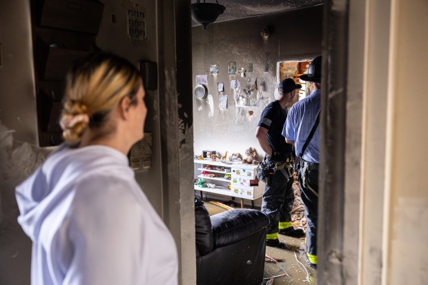 A tenant watching the FDNY inspect her apartment after a fire broke out in her Bay Ridge Ave home in Brooklyn, on Wednesday, Sept. 10, 2025. (Shawn Inglima/ New York Daily News)