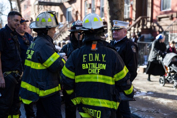 Firefighters respond after a man was seriously injured after jumping from his fourth-floor apartment in Williamsburg during a fire on Tuesday. 