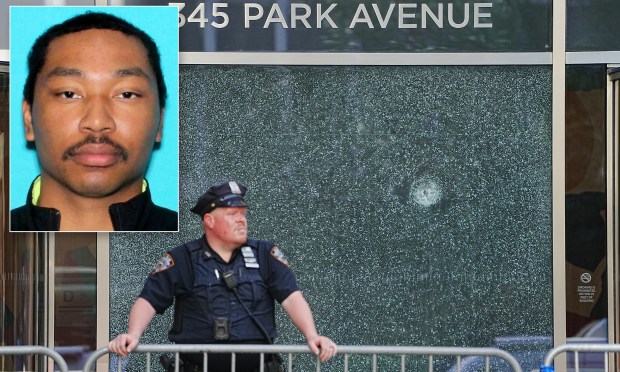 A bullet hole is seen in the window of 345 Park Ave.