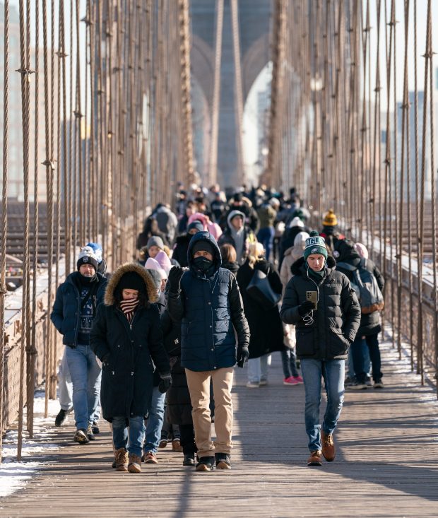 Visitors to the Brooklyn Bridge brave the cold Monday, Dec. 23, 2024 in Manhattan, New York. (Barry Williams/ New York Daily News)