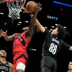 Brooklyn Nets guard Nolan Traore (88) blocks Toronto Raptors guard Immanuel Quickley (5) during the first half of an NBA basketball game, Sunday, Dec. 21, 2025, in New York. (AP Photo/Yuki Iwamura)