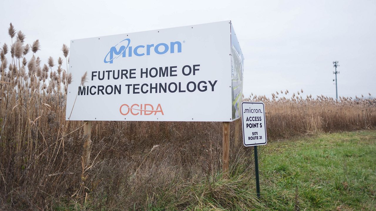 a sign in a field that reads 'future home of micron technology'