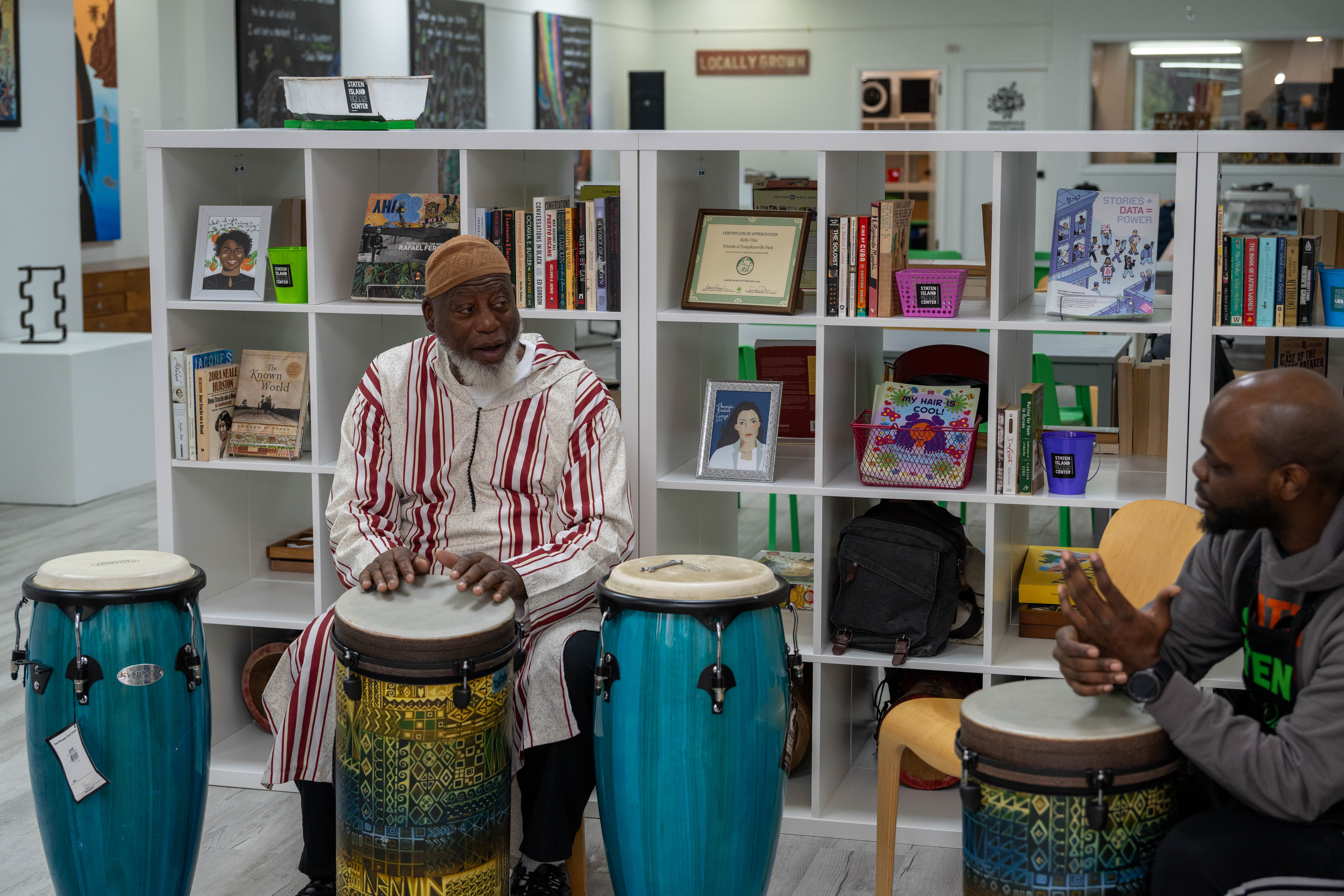 Iman Zulgarnain Addu-Shahid plays the drums at the grand opening of the Staten Island Urban Center’s new storefront at 206 Bay Street in Tompkinsville on Saturday, December 6, 2025. (Owen Reiter for the Advance/SILive.com)