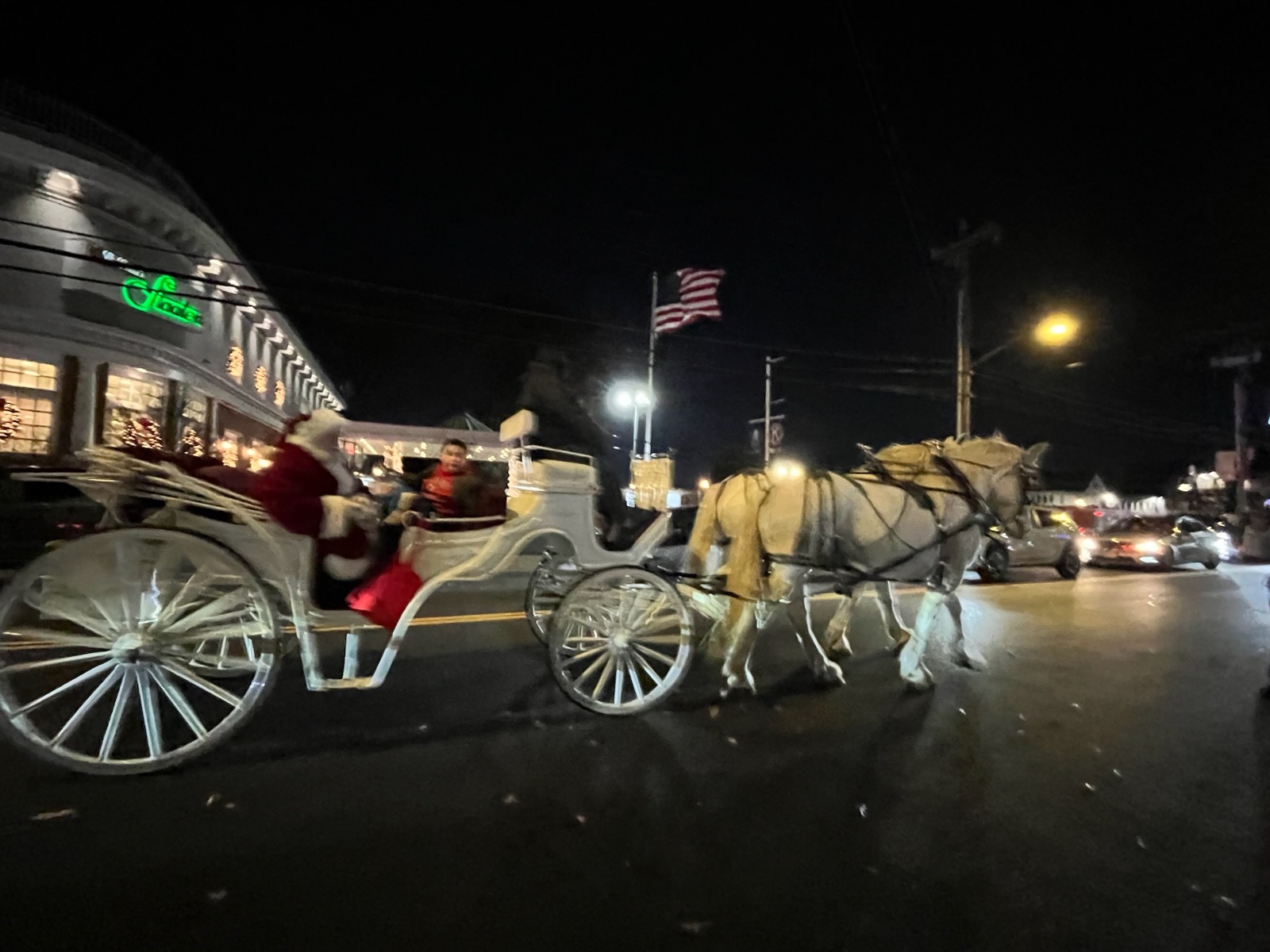 Local businesses offered festive treats along Forest Avenue as Santa arrived in a horse-drawn carriage for the community celebration.