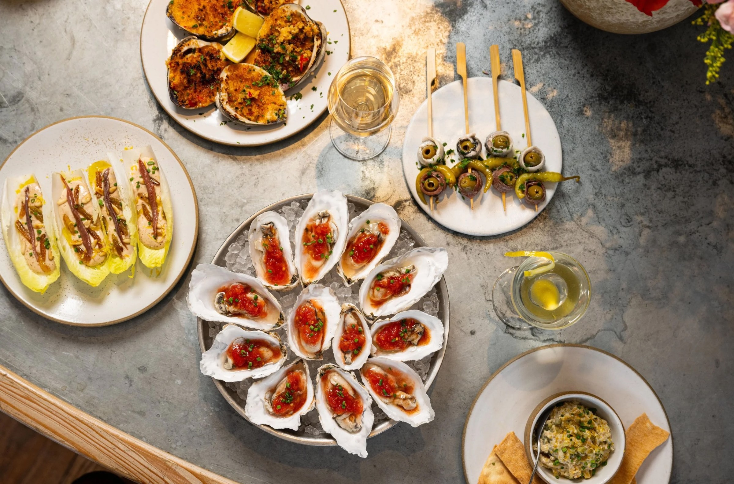 A table of plated food including oysters.