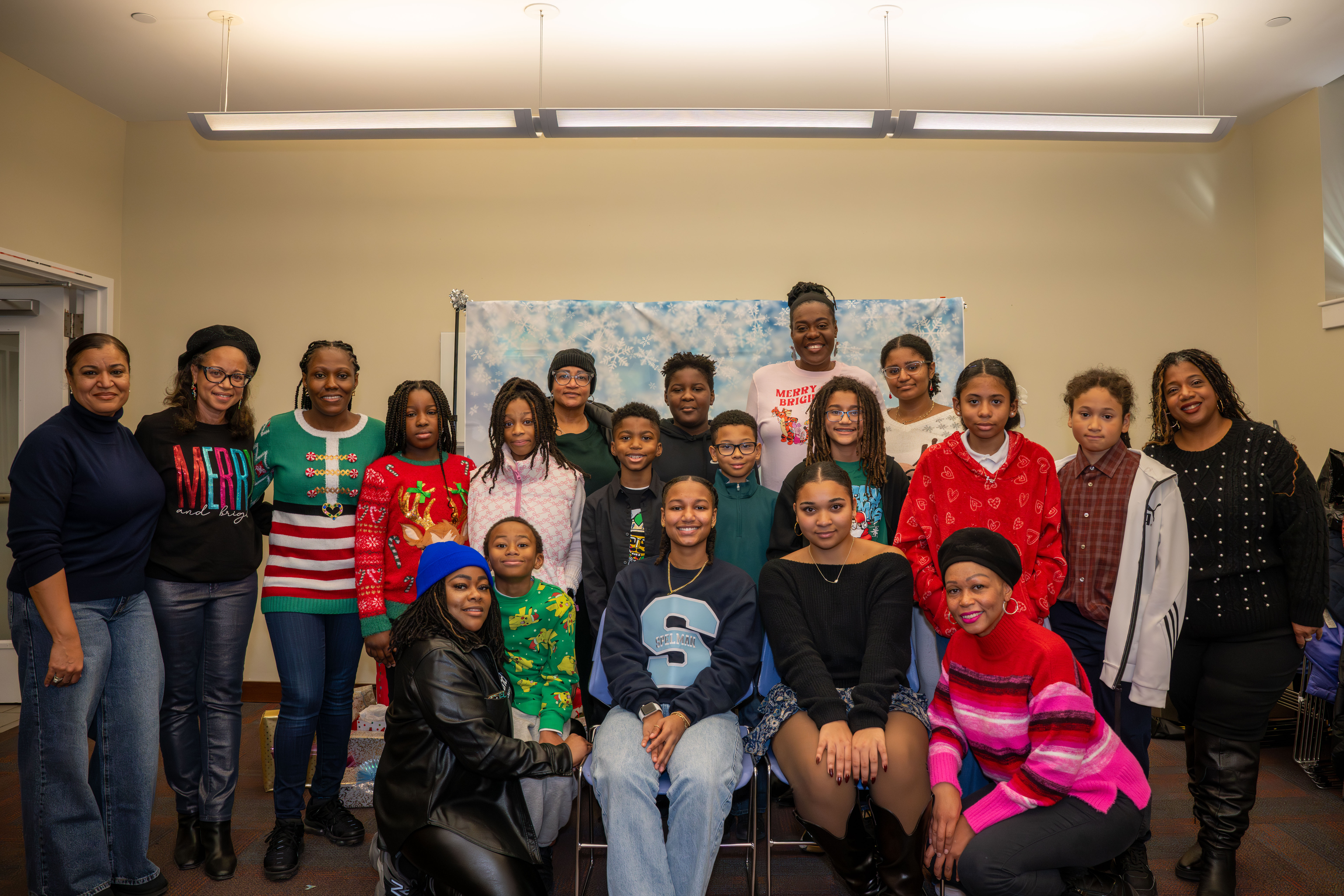 Kamora Freelend (wearing a Spelman College shirt), the youngest African-American female pilot to earn her private pilot license, and student pilot Sophie Robinson with middle school students and parents at a meeting of Jack and Jill of America, Staten Island Tweens at the College of Staten Island in Willowbrook on Saturday, Dec. 20, 2025. (Owen Reiter for the Advance/SILive.com)