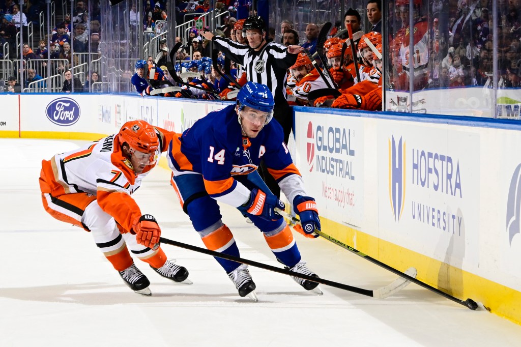 Bo Horvat of the New York Islanders and Frank Vatrano of the Anaheim Ducks fight for the puck.