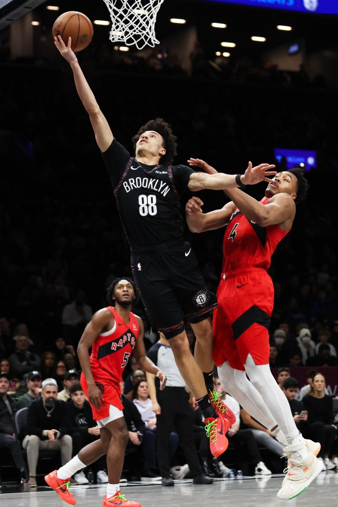 Brooklyn Nets' Nolan Traore (88) drives to the basket past Toronto Raptors' Scottie Barnes (4) during the second half of a game at the Barclays Center in Brooklyn, N.Y. on Sunday, Dec. 21, 2025.