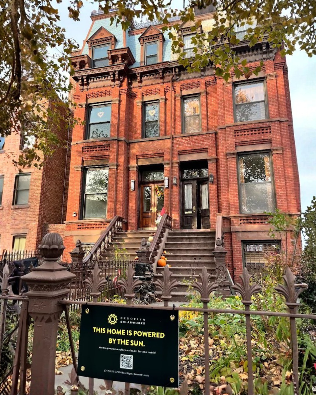 Brooklyn brownstone with a sign out front -- this home powered by the sun 