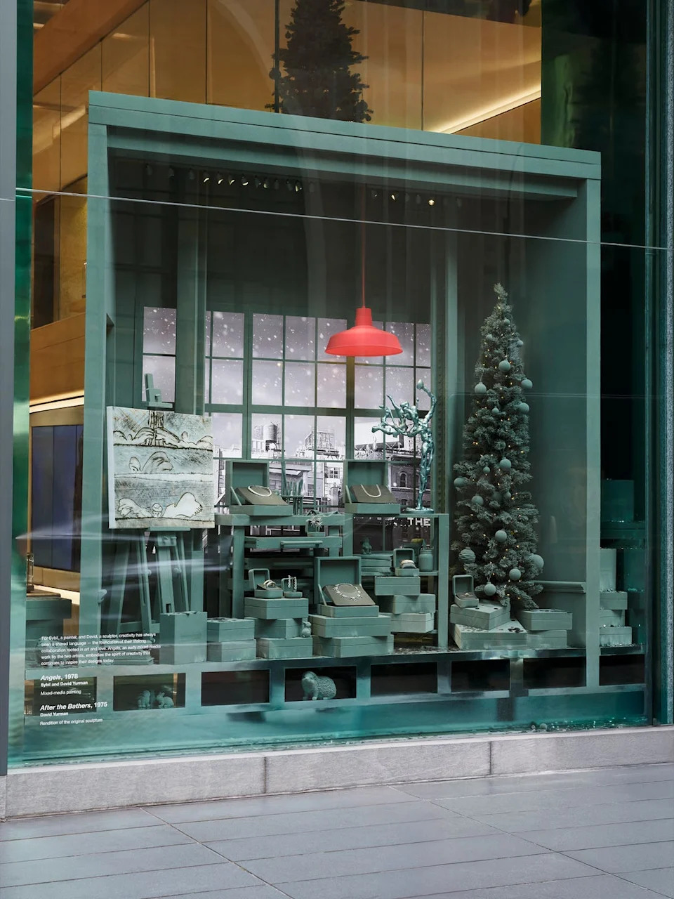 display window featuring a holiday themed setup with art and jewelry