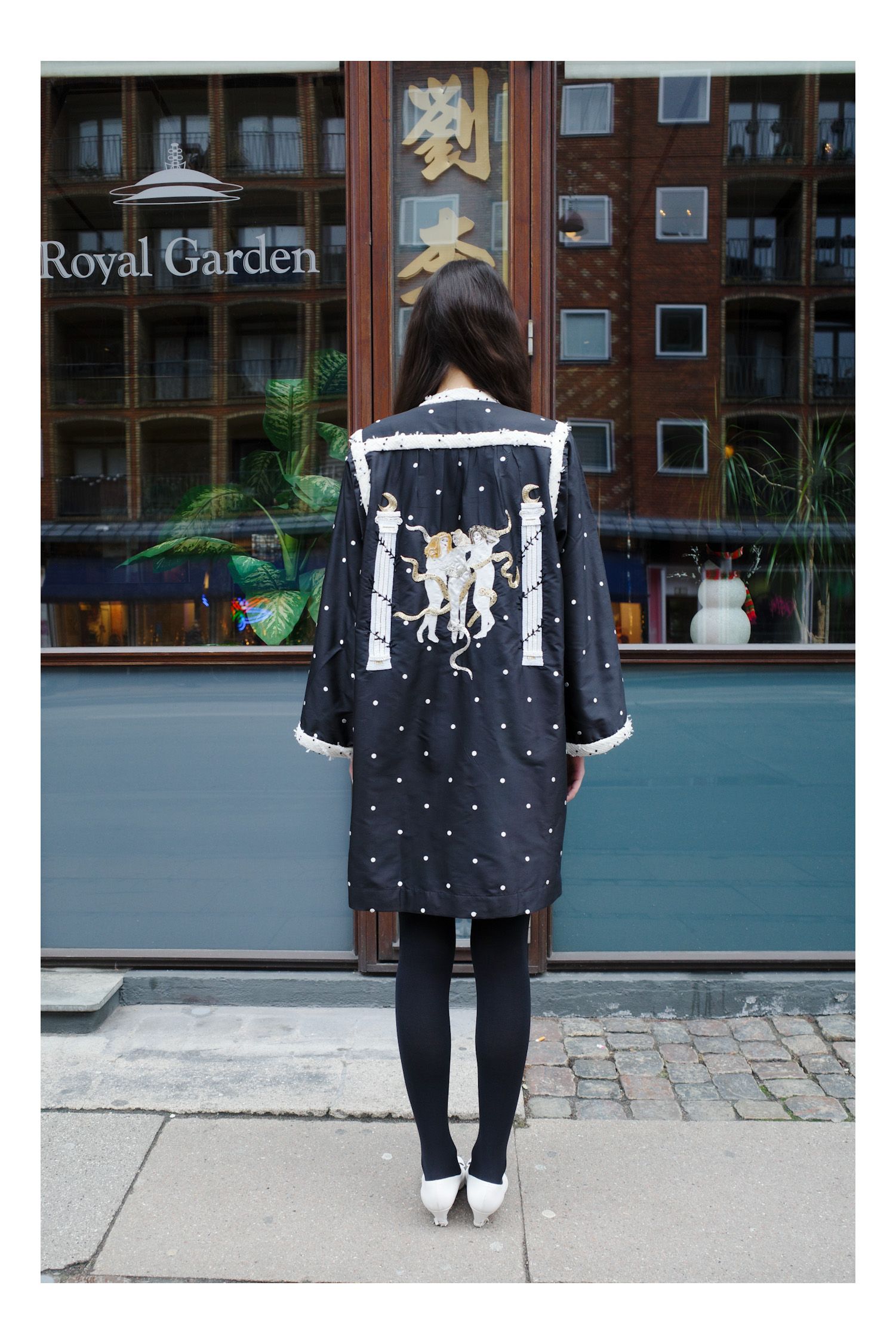 Image may contain Clothing Coat Person Teen Footwear and Shoe