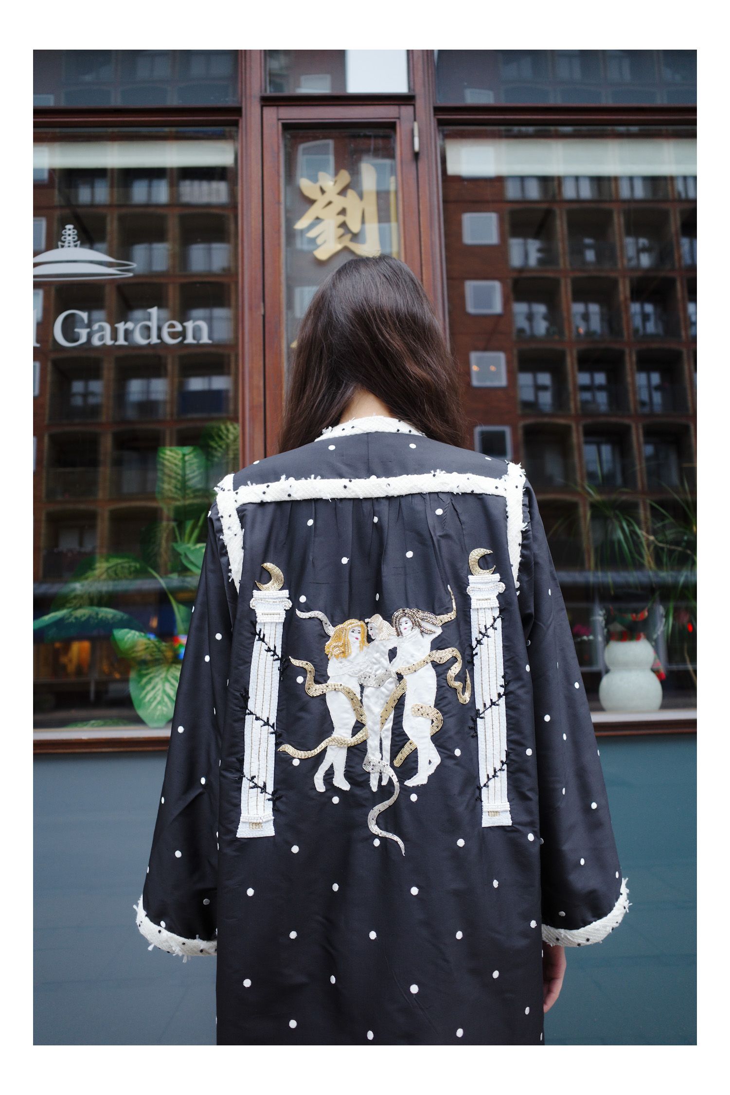 Image may contain Clothing Dress Fashion Coat Formal Wear Gown Long Sleeve Sleeve Robe Adult Person and Jacket