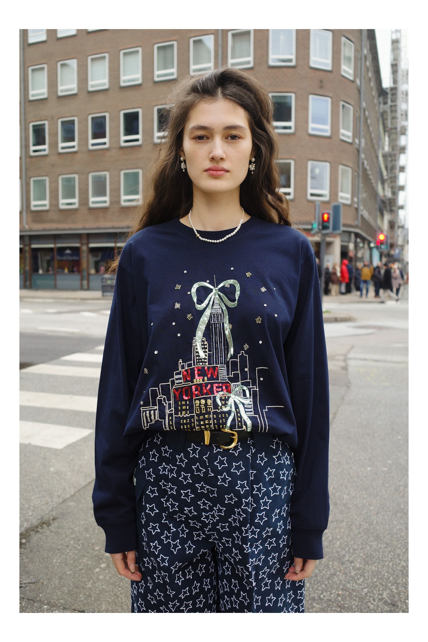 Image may contain Clothing Long Sleeve Sleeve TShirt Blouse Knitwear Sweater City Adult Person and Sweatshirt