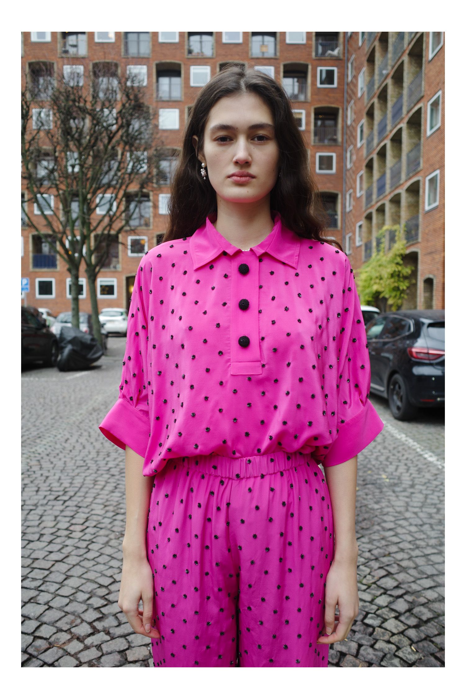 Image may contain Blouse Clothing Sleeve Face Head Person Photography Portrait Coat City Car and Transportation