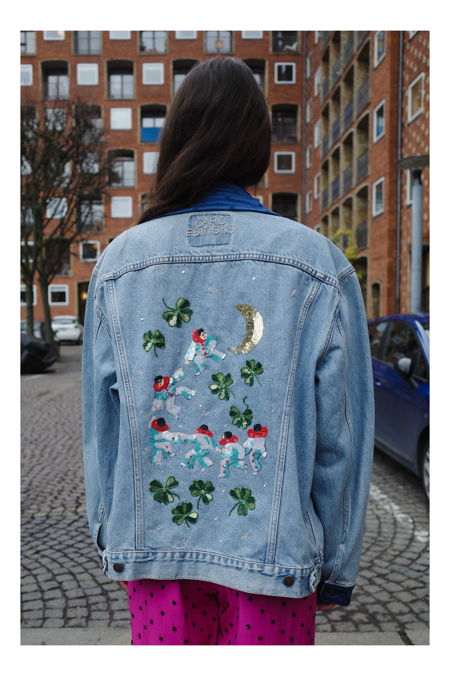 Image may contain Clothing Coat Jacket Pants City Jeans Blazer Adult Person Urban and Pattern