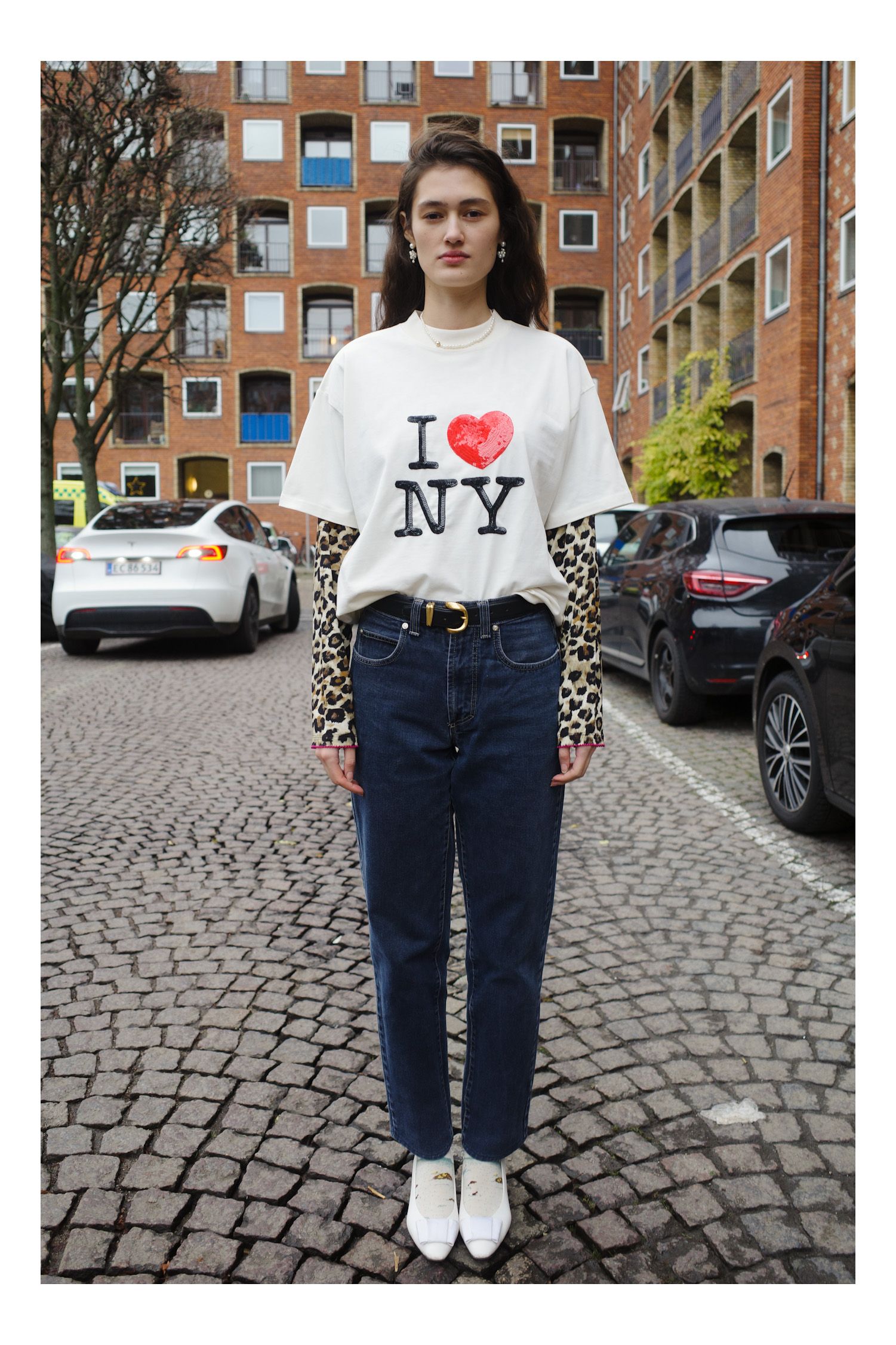 Image may contain Clothing Pants TShirt Jeans Person Teen City Standing Road Street Urban Face and Head