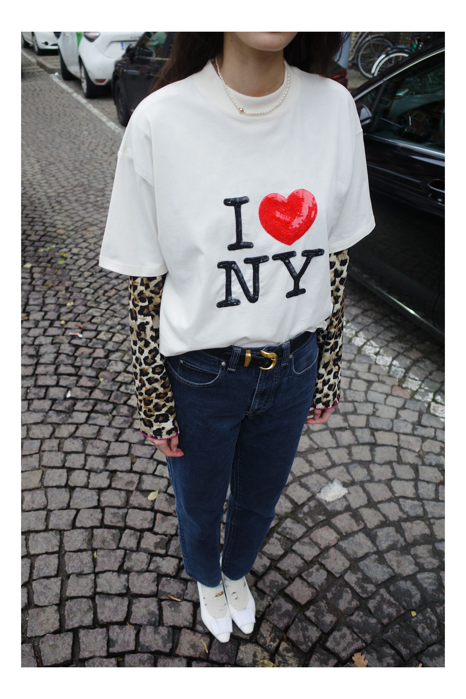 Image may contain Clothing TShirt Pants Person Teen Sleeve Jeans Accessories Jewelry Necklace and Car