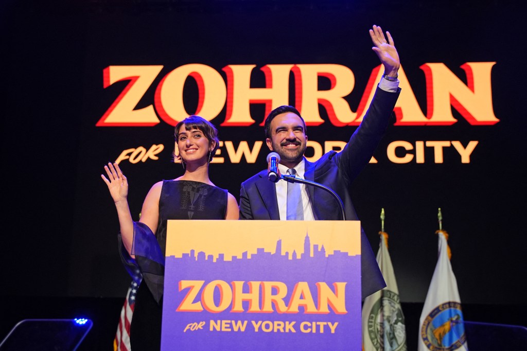 New York City Mayoral candidate Zohran Mamdani and his wife Rama Duwaji wave to supporters at an election night event.