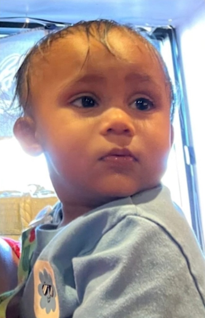 Charlie Ramraykha, a 15-month-old child, in a blue shirt with a small sticker.