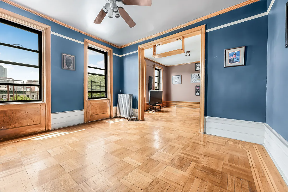 living room with blue walls, ceiling fan