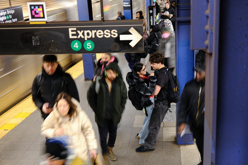 A couple embracing on a subway platform.