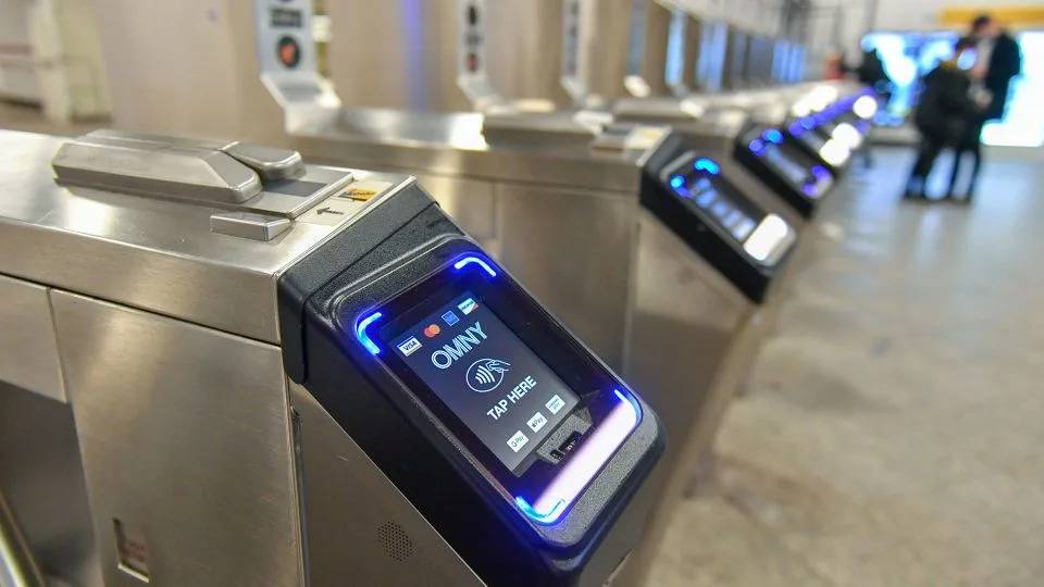 Monitors for the new Metropolitan Transportation (MTA) contactless fare payment system, known as the One Metro New York (OMNY), are seen on turnstiles at a subway station in New York. - Erik Pendzich/Shutterstock