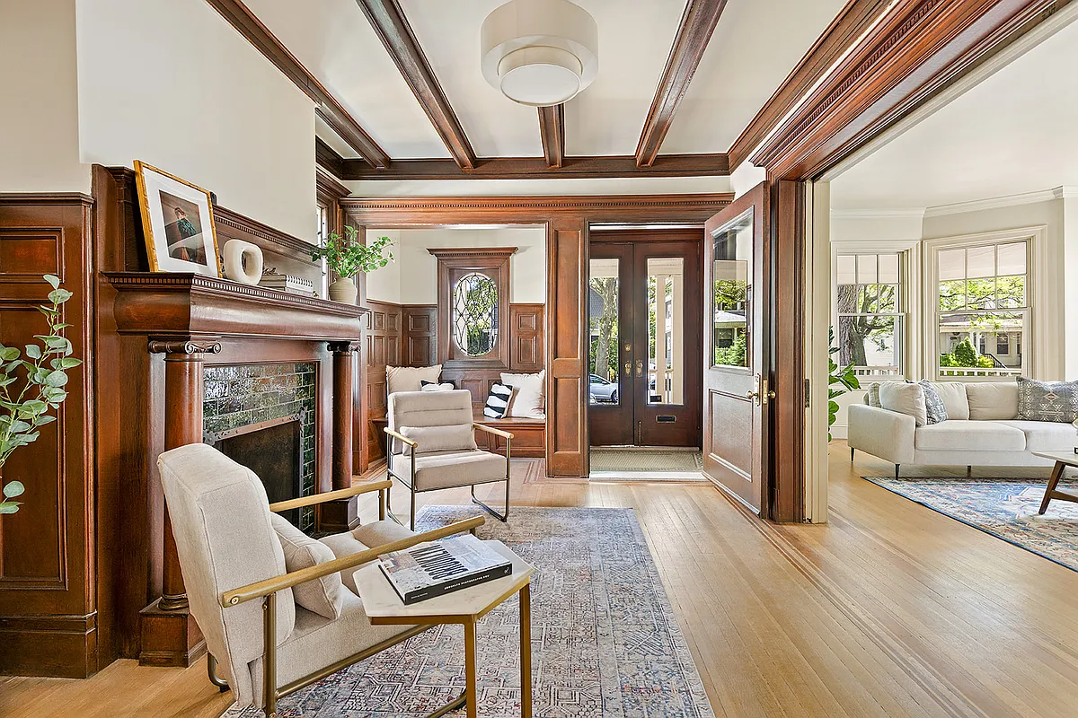 room with beamed ceiling and mantel