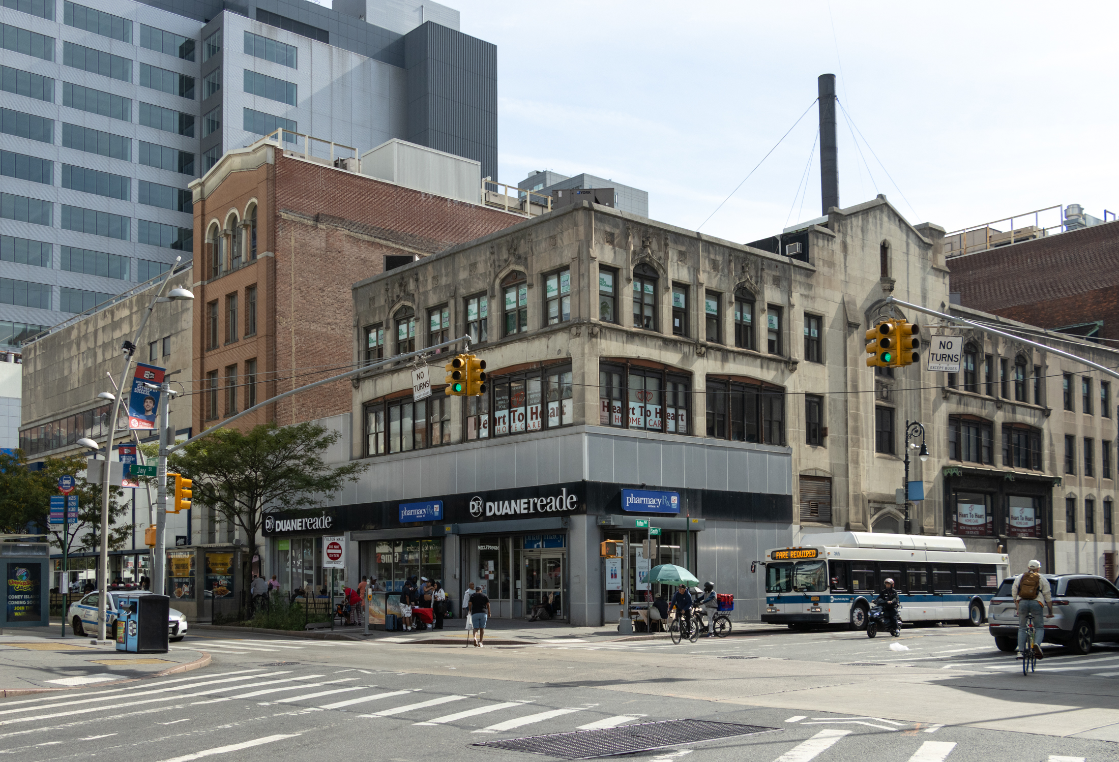 corner in downtown brooklyn with pedestrian and car traffic