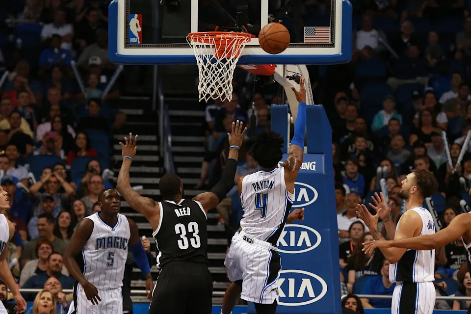 Mar 29, 2016; Orlando, FL, USA; Orlando Magic guard Elfrid Payton (4) drives to the basket as Brooklyn Nets forward Willie Reed (33) attempted to defend during the second half at Amway Center. Orlando Magic defeated the Brooklyn Nets 139-105. Mandatory Credit: Kim Klement-USA TODAY Sports