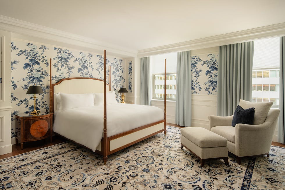 luxury bedroom with floral wallpaper and elegant furnishings