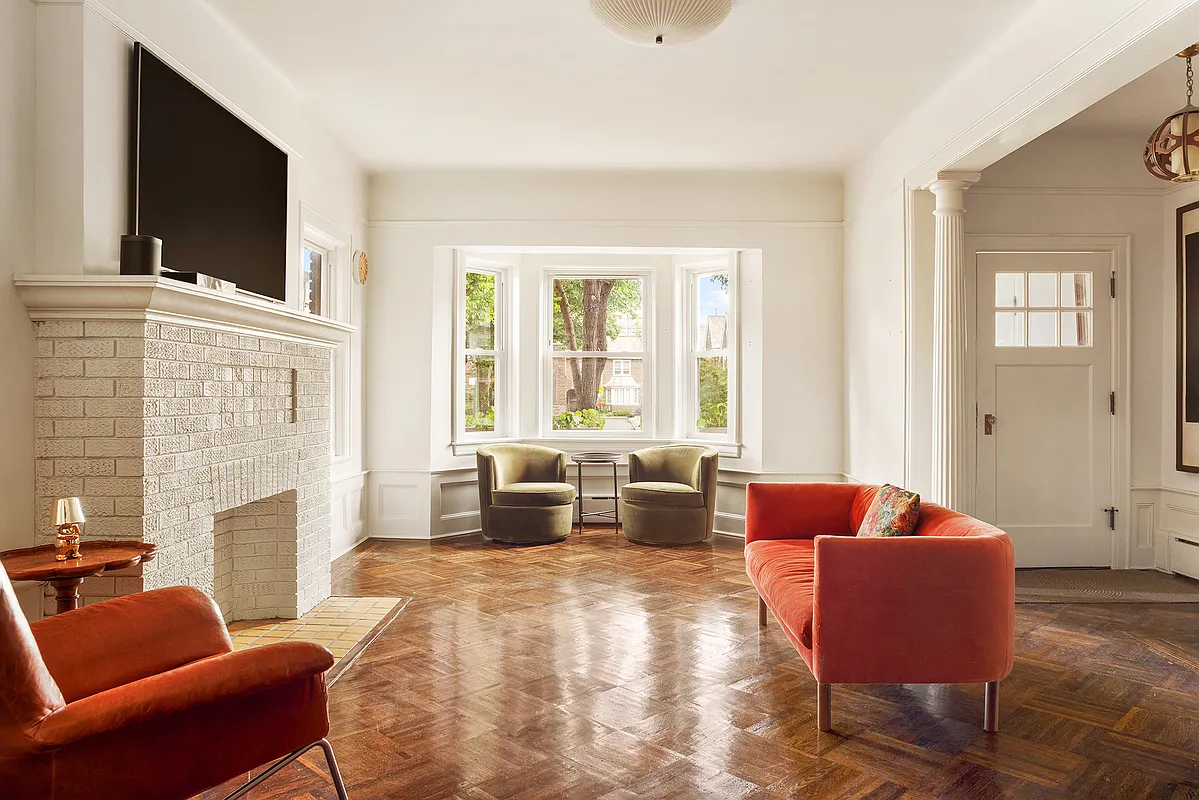flatbush - living room with brick mantel, columns, parquet floor