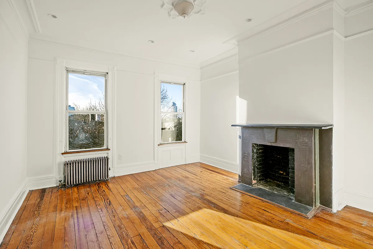 greenpoint living room with wood floors, stone mantel